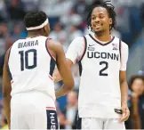  ?? JESSICA HILL/AP ?? Uconn guard Tristen Newton, right, celebrates with teammate Hassan Diarra in the second half against Marquette on Feb. 17 in Hartford.