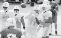  ?? MIKE STOCKER/SUN SENTINEL ?? Dolphins receiver DeVante Parker catches a pass during practice Wednesday. He has been dealing with a hamstring injury.