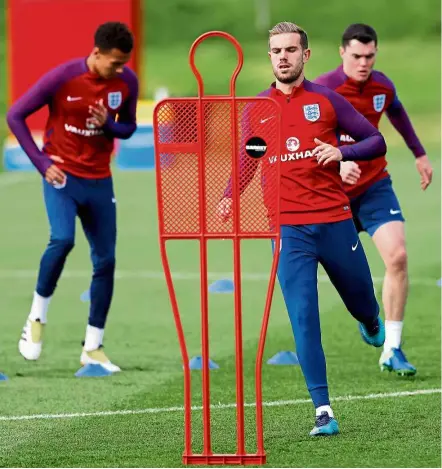  ?? — Reuters ?? Calm before the storm: England’s Jordan Henderson (centre) training with team-mates at St. George’s Park ahead of their World Cup qualifying match against Malta today.