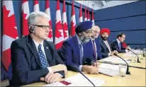  ?? CP PHOTO ?? National Defence Minister Harjit Singh Sajjan, second left, joins fellow MPS as the government reacts to the Auditor General’s fall report during a press conference at the National Press Theatre in Ottawa on Tuesday.