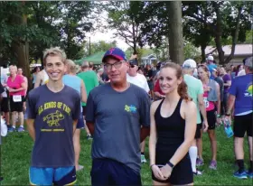  ?? BOB KEELER — MEDIANEWS GROUP ?? Zach Hoagland, left, was the first place male finisher in this year’s Moyer Indoor/Outdoor 5K, and Sarah Hughes, right, was first place female finisher. At center is Bob Williamson, Moyer Indoor/Outdoor general manager, and the founder of the annual run, which this year was held for the 25th time.