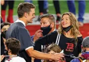  ?? KEVIN C. COX/GETTY IMAGES/TNS ?? Tampa Bay Buccaneers quarterbac­k Tom Brady celebrates with Gisele Bundchen after winning Super Bowl LV at Raymond James Stadium on Feb. 7, 2021, in Tampa, Florida.