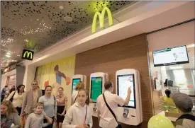  ?? PHOTO: BLOOMBERG ?? Customers use digital menu screens to order food at McDonald’s Russian fast food restaurant in Moscow. The chain is pioneering hi-tech touch screens that allow customers to create their own meals.