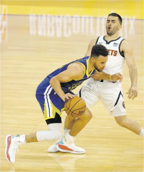  ?? (Photo: AFP) ?? Stephen Curry (foreground) of the Golden State Warriors is guarded by Facundo Campazzo of the Denver Nuggets at Chase Center in San Francisco, California, on Monday.