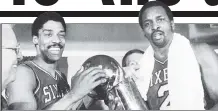  ?? AP ?? GOLDEN MOMENT: Moses Malone (right) celebrates the 1983 NBA title with Julius Irving.