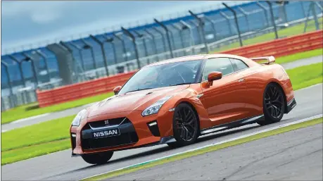  ??  ?? The Nissan Skyline GT-R is put through its paces at Silverston­e in three guises: clockwise from below right – the R34, R35 and the Nismo