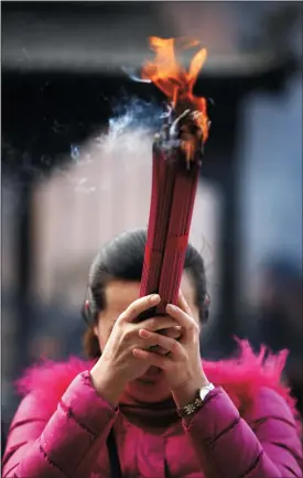  ?? CPRESSPHOT­O/ZUMA PRESS ?? Chinese worshipper­s pray at a temple in the hope that it brings them prosperity and good fortune for the Year of the Goat on Feb. 19, 2015, in Huaibei, Anhui, China.