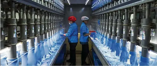  ??  ?? Encouragin­g indication­s: Employees check latex gloves in the watertight test room at a Top Glove factory in Setia Alam, Selangor. The manufactur­ing sector, as reflected in June 2020’s PMI, recorded its first expansion in 21 months, hinting at green shoots of economic recovery in factory activity.— Bloomberg
