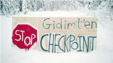  ?? — THE CANADIAN PRESS/FILES ?? A sign marks a checkpoint erected by the Gidimt’en clan of the Wet’suwet’en First Nation, blocking access to a planned pipeline in the territory.
