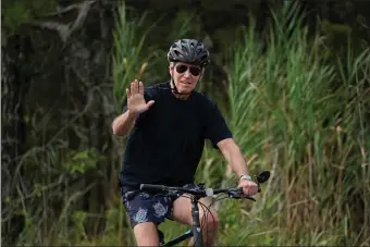  ?? MANUEL BALCE CENETA — THE ASSOCIATED PRESS ?? Get ready for more reporting on President Biden at Gordons Pond in Rehoboth Beach, Del., riding his bike out of reach of reporters.