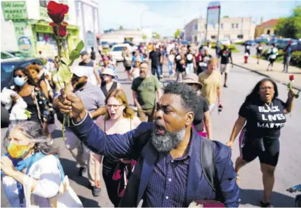  ?? (Photos: AP) ?? This man joins others in a march to the scene of a shooting at a supermarke­t in Buffalo, New York on Sunday, May 15, 2022.
