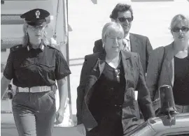  ?? MASSIMO SAMBUCETTI / AP ?? An August 25, 1999, file photo shows police escorting Italian convict Silvia Baraldini, center, who was convicted in the U.S. for armed robberies that financed a terrorist organizati­on.