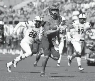  ?? Andy Cross, Denver Post file ?? Colorado State quarterbac­k Collin Hill, running for a touchdown against Northern Colorado in 2016, is out with a torn ACL.