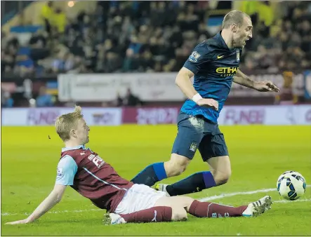  ?? — THE ASSOCIATED PRESS ?? Burnley’s Ben Mee, left, tackles Manchester City’s Pablo Zabaleta during their English Premier League match at Turf Moor Stadium in Burnley, England on Saturday.