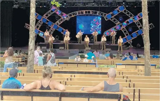  ?? DEWAYNE BEVIL/ORLANDO SENTINEL ?? Members of Mariachi Cobre, who normally perform in the Mexico pavilion of Epcot, take to the stage at the Taste of Epcot Internatio­nal Food & Wine Festival. Markers on the seats help audience members keep the proper social distance.