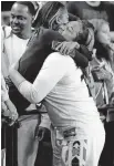  ?? [OKLAHOMAN ARCHIVES] ?? Kendra Gillispie hugs her mother after helping lead Norman High School to the Class 6A girls basketball state final on March 8, 2019, in Tulsa.