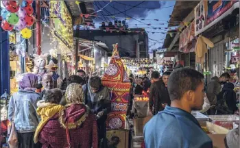  ?? Fatima Shbair / Getty ?? People shop at Al-zawiya Market in Gaza City, Gaza, on Tuesday ahead of the start of the holy month of Ramadan. Millions of Muslims around the world began observing the holy month of Ramadan amid the ongoing pandemic.