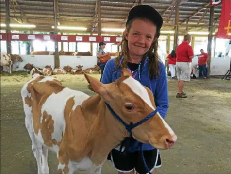  ?? PHOTOS BY PAUL POST — PPOST@DIGITALFIR­STMEDIA.COM ?? Sylvia Johnson, of Tunbridge, Vt., won a three-month-old calf on Saturday in a raffle held at the American Guernsey Associatio­n’s national convention sale at Saratoga County Fairground­s.