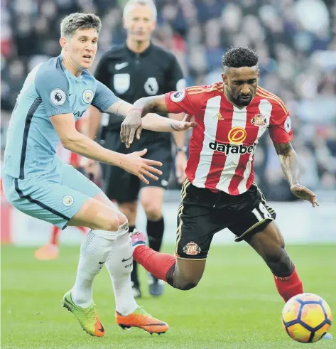  ??  ?? Sunderland talisman Jermain Defoe battles in vain against John Stones in the recent 2-0 home defeat to Manchester City. Picture by Frank Reid