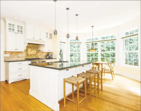  ?? PlanOmatic ?? The kitchen at 28 Briar St. in Rowayton features Alrich Cabinetry, Brazilian Verde Karzai granite on the countertop­s, high-end appliances, a center island and a sunny breakfast area. The shingle-style colonial is on a 0.48-acre lot and has 4,982 square feet of living space..