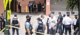  ?? PAT NABONG/SUN-TIMES ?? Police gather outside Illinois Masonic Medical Center, where an officer in serious condition was brought after Thursday’s incident.