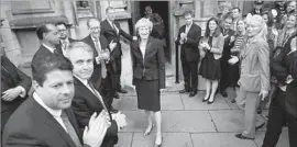  ?? Christophe­r Furlong Getty Images ?? IN LONDON, Theresa May, center, prepares to make a statement after Andrea Leadsom pulled out of the contest to become Britain’s Conservati­ve Party leader.