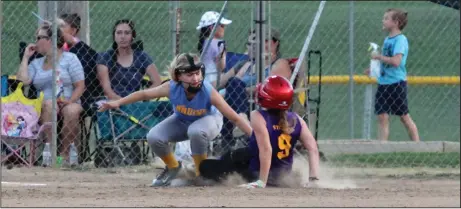  ?? PHOTOS BY MIKE BUSH/NEWS-SENTINEL ?? Above: The Tigers' Sasha Loock is tagged out by Bruins third baseman Jordan Meyers in the Lodi BOBS 16 and under softball championsh­ip game. Loock and the Tigers posted a wild 21-11 win. Below: Tigers pitcher Maura Ambriz throws a pitch in the bottom...