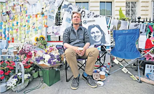  ??  ?? Surrounded by images of his wife, Mr Ratcliffe spent two weeks on hunger strike outside the Iranian Embassy in London