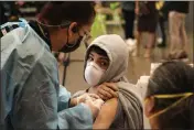  ?? DAMIAN DOVARGANES — THE ASSOCIATED PRESS FILE ?? A student looks back at his mother as he is vaccinated at a COVID-19vaccinat­ion clinic for students 12and older in San Pedro.