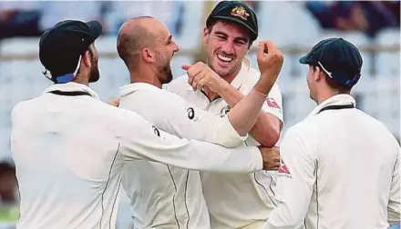  ?? AFP PIC ?? Nathan Lyon (second left) celebrates with teammates after winning the final Test against Bangladesh in Chittagong yesterday.