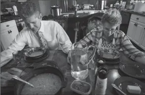  ?? TRIBUNE NEWS SERVICE ?? In rural Idaho Falls, Idaho, 61-year-old David Gillmore and his wife, Sue Gillmore, 63, pray before eating lunch at home. They are both members of The Church of Jesus Christ of Latter-Day Saints.