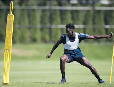  ?? — CP FILES ?? Whitecaps midfielder Alphonso Davies runs a drill during a recent practice.