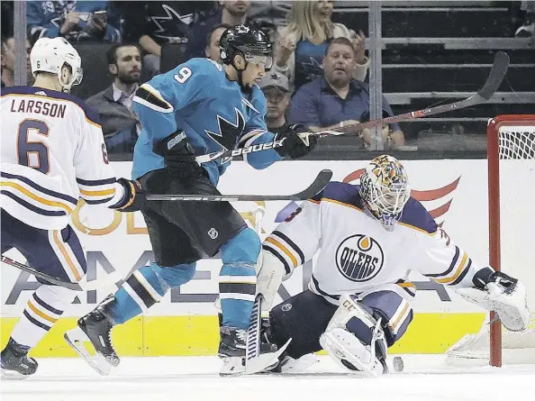  ?? JOSE SANCHEZ/THE ASSOCIATED PRESS MARCIO ?? Oilers goalie Cam Talbot stops Sharks forward Evander Kane during the first period on Tuesday in San Jose, Calif. The Sharks went on to win 5 -2.