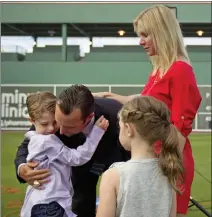  ?? DAVID GOLDMAN — AP FILE PHOTO ?? Red Sox pitcher Tim Wakefield hugs his son Trevor, 7, as his wife Stacy and daughter, Brianna, 6, look on after Wakefield announced his retirement from baseball in 2012. Stacy Wakefield died Wednesday.