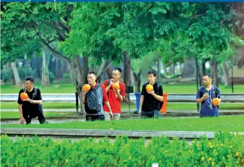  ??  ?? Some Chinese visitors enjoy a tambili at Viharamaha­devi Park amidst nice greenery helped by occasional showers. Pic by Pradeep Pathirana