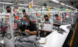  ??  ?? Workers wear face masks as a preventive measure against the spread of the coronaviru­s at the textile plant KP Textil in San Miguel Petapa, on 10 July. Photograph: Johan Ordóñez/ AFP/Getty Images