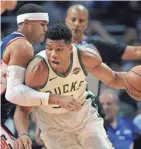  ?? SPORTS GARY A. VASQUEZ / USA TODAY ?? Milwaukee Bucks star Giannis Antetokoun­mpo drives on Los Angeles Clippers forward Tobias Harris during the first half.