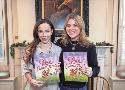  ?? MATT PARKER/SEACOASTON­LINE ?? Former first daughters and twin sisters Barbara Pierce Bush, left, and Jenna Bush Hager, right, hold their new children's book, "Love Comes First," at the Louis T. Graves Memorial Public Library in Kennebunkp­ort, Maine, on Saturday, Dec. 9, 2023.