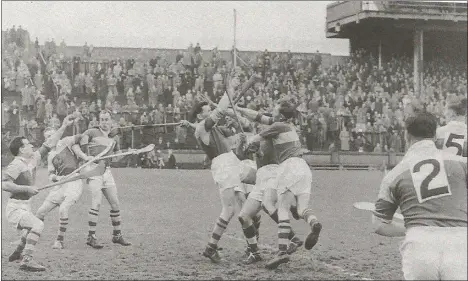  ??  ?? Netminder Art Foley (left) keeping his eye on the ball amid a sea of bodies and swinging hurls around the goalmouth.