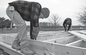  ?? TY WRIGHT/EAGLE GAZETTE ?? Levi Kline, 17 of Carroll, hammers a nail into the floor of a house he and other Fairfield Career Center students are building for Habitat for Humanity on Nov. 16. The finished constructi­on on the home is expected to be completed in September of 2023.