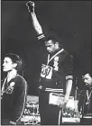  ?? (AFP) ?? This file photo taken on Oct 17, 1968 shows US athletes Tommie Smith (center), and John Carlos (right), raising their gloved fists in the Black Power salute to express their opposition to racism in the USA during the US national anthem, after receiving...