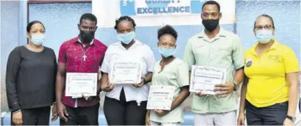  ?? ?? ‘Pride, Quality and Excellence’ was the theme for the Beaches Ocho Rios Awards Ceremony for Internatio­nal Housekeepi­ng Week. At right is Gia Redway, executive housekeepe­r and left is her assistant, Chandi Nattoo celebratin­g with a few of their awardees, (from second left) Jamari Williamson, Best Public Area (PM) Performanc­e Award; Ingrid White, Best Public Area (AM) Performanc­e Award; Georgie-ann Cox, The Golden Broom Award; and Troy Ralph, Best Kept Houseman Section Award.