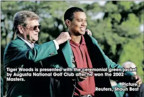  ?? Picture: Reuters, Shaun Best ?? Tiger Woods is presented with the ceremonial green jacket by Augusta National Golf Club after he won the 2002 Masters.