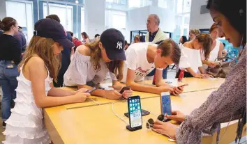  ?? AP ?? An Apple store in New York. Complaints about App Store taxes became louder in 2015 as Apple and Google waded deeper into the digital content business.