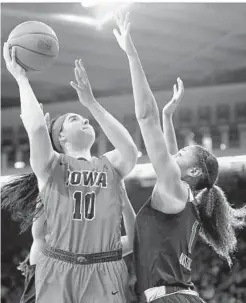  ?? CHARLIE NEIBERGALL/ASSOCIATED PRESS ?? Iowa’s Megan Gustafson, shooting over Maryland’s Shakira Austin, scored 24 points in the second half to help the Hawkeyes move into a tie for first in the Big Ten.