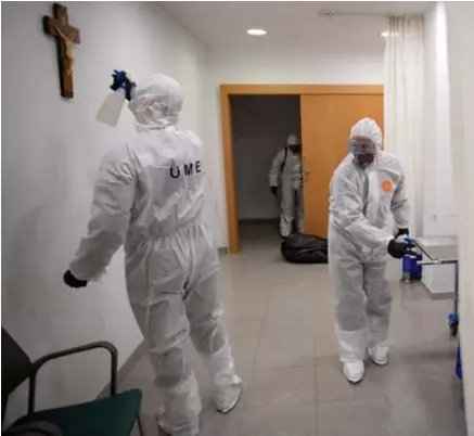  ?? © afp ?? Een kruisbeeld wordt ontsmet tijdens een schoonmaak­beurt in een ziekenhuis in Barcelona.