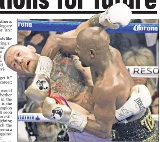  ?? EPA ?? HIT ME WITH YOUR BEST SHOT: Conor McGregor takes a Floyd Mayweather punch during their fight Saturday night in Las Vegas.