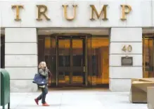  ?? AP PHOTO/MARK LENNIHAN, FILE ?? A woman walks past the Trump Building in New York’s financial district in January 2021.
