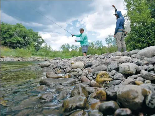  ?? PHOTOS BY MATT DAHLSEID/THE NEW MEXICAN ?? Fly-fishing guide Wes Dyer, right, founder and CEO of the nonprofit AWOL Anglers, instructs Mike Anderson, a 25-year veteran from San Antonio, Texas, during a July 16 trip to Trout Stalker Ranch near Chama.