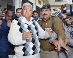  ?? PTI ?? RJD supremo Lalu Prasad Yadav escorted by police officials after being convicted by the special CBI court in the fodder scam case in Ranchi on Saturday. —